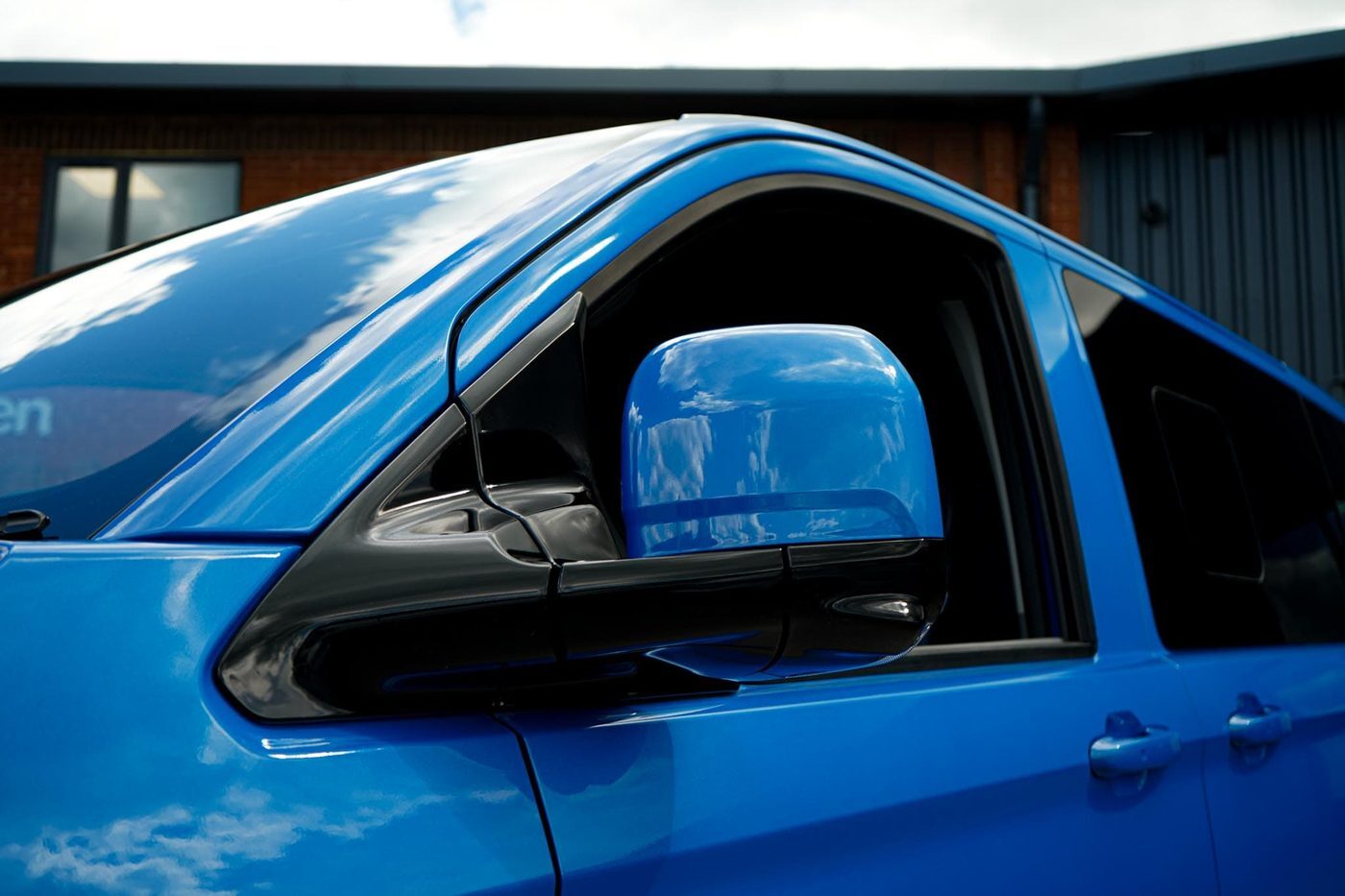 Colour-matched mirror and window line on a Van Haven build